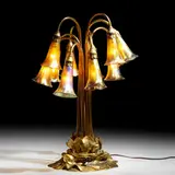 Ten-light Lily table lamp by Tiffany Studios, c. 1910, gilt bronze, hand-blown Favrile glass, sold Jul 2024