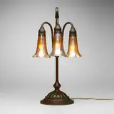 Tiffany Studios, Three-light Lily table lamp, c. 1910, patinated bronze, hand-blown Favrile glass