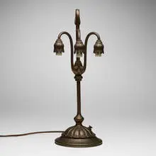 Three-light Lily table lamp base by Tiffany Studios, c. 1910, acid-etched and patinated bronze, sold Jul 2024