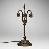 Three-light Lily table lamp base by Tiffany Studios, c. 1910, acid-etched and patinated bronze, sold Jul 2024