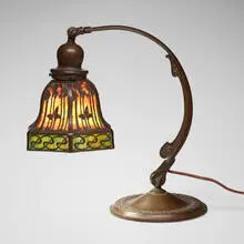 Teroca sunset overlay desk lamp by Handel, c. 1910, patinated metal, slag glass, sold Jul 2024