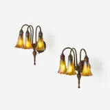 Three-light Lily sconces, pair by Tiffany Studios, c. 1910, patinated bronze, hand-blown Favrile glass, patinated copper, sold Jul 2024