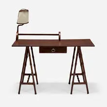 attribution Jacques Adnet, Desk with lamp, c. 1950, leather over wood, saddle-stitched leather over steel, vellum, nickel