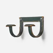 Jacques Adnet, Wall hook, c. 1965, saddle-stitched leather over steel