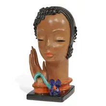 attribution Rudolf Knörlein for Goldscheider, Art Deco bust — African woman's head with a raised hand and flower, #7604, Austria