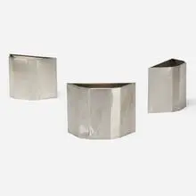 wastepaper baskets from Price Tower, Bartlesville, Oklahoma, set of three by Frank Lloyd Wright, 1956, stainless steel, sold Jun 2019