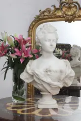 Untitled by Nilda Boero, an Italian carved white marble bust of a lady in a flowing dress, on a waisted socle, sold Mar 2021
