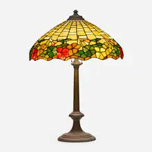 attribution Wilkinson Co., Floral border table lamp, c. 1910, patinated metal, leaded glass
