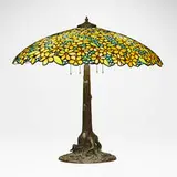 Tree trunk table lamp base by Unique Art Glass & Metal Company, c. 1906-10, leaded glass, patinated metal, sold Mar 2024