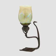 Candlestick by Tiffany Studios, c. 1910, hand-blown Favrile glass, patinated bronze, sold Mar 2024