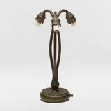 Three-light Lily table lamp base by Tiffany Studios, c. 1910, patinated bronze, sold Mar 2024