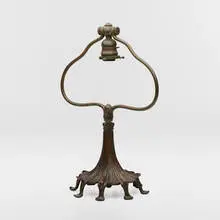 Adjustable harp table lamp base by attribution Tiffany Studios, c. 1910, patinated bronze, sold Mar 2024