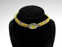 A Georg Jensen Choker, by Naja Salto, the purple, yellow and red enamelled panel on coloured cord choker,, offered Nov 2004