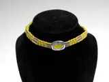 Naja Salto, A Georg Jensen Choker,, the purple, yellow and red enamelled panel on coloured cord choker,