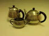 Liberty & Co., A three piece pewter tea set,