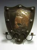 A shield shaped copper double candle sconce, by Alexander Ritchie of Iona, A shield shaped copper double candle sconce,, offered Nov 2004