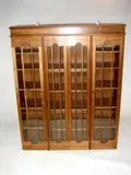Alan Peters Obe, A walnut and sycamore lined Bookcase, fitted with four arched glazed doors,
