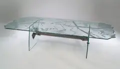 Danny Lane, A glass Occasional Table, designed in 1988, polished glass and wheel engraved frame with steel stretcher,