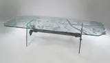 Danny Lane, A glass Occasional Table, designed in 1988, polished glass and wheel engraved frame with steel stretcher,