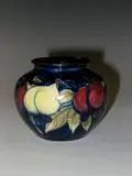 Moorcroft, A small 'Plum Wisteria' pattern vase,