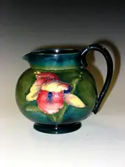 An 'Orchid' pattern jug, by Moorcroft, offered May 2004