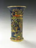Carlton Ware, A 'China' pattern vase,, 2762, the cylindrical body gilt painted and enamelled with figures in garden, reserved on a blue ground,