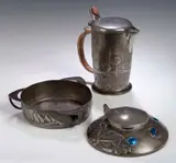 Liberty & Co., A 'Tudric' pewter and enamel inkwell, designed by Archibald Knox,