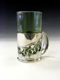 Liberty & Co., A 'Tudric' polished pewter toddy, designed by Archibald Knox,