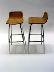 A pair of high stools, by Charlotte Periand, woven wicker seat and back rest, on tubular chronium plate legs, sold May 2004