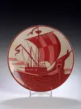 William De Morgan, A circular red lustre plate,