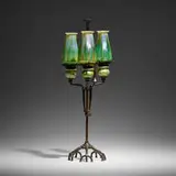 Rare adjustable candleholder with snuffer by Tiffany Studios, c. 1910, hand-blown Favrile glass, patinated bronze, sold Oct 2023