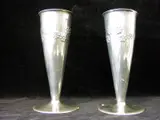 Liberty & Co., A pair of 'Tudric' polished pewter spill vases,