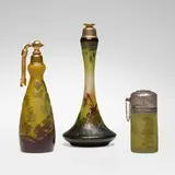 Galle, Collection of three perfume atomizers, c. 1915, acid-etched cameo glass, brass-washed metal, silver