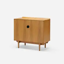 cabinet by Finn Juhl, c. 1951, walnut, enameled brass, sold Jan 2018