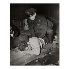 Untitled (Cop giving artificial respiration) by Weegee, c. 1941, Ferrotyped gelatin silver print; the photographer's 'Weegee the Famous' and Weegee/Photo-Representatives credit stamps, sold Jan 2026
