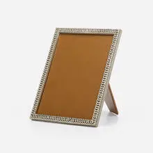 Frame by Hermès, c. 1950, silver plate, leather, glass, sold Jul 2023
