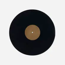 Christian Marclay, Untitled (Record Without a Groove), 1987, black vinyl groove-less record with golden label in black suede pouch with gold lettering