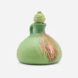 Carved Mat whiskey jug with ear of corn and stopper by Rose Fechheimer for Rookwood Pottery, 1905, glazed earthenware, sold Jun 2025