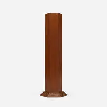 Hexagonal weed vase by Frank Lloyd Wright, 1953 / 1954, mahogany, copper-anodized aluminum, sold Oct 2024