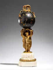 “Pendule au Globe” table clock in gilded bronze, Louis XVI style by Alfred Daubrée, the spherical dial is surmounted by a gilded bronze band that forms a knot in two rings of intertwined laurel, offered Sep 2026