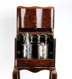 French tea cabinet with sterling silver containers by Tahan À Paris. Jean-Pierre Alexandre Tahan, Veneered in elm burl and inlaid with purple ebony; the front panel opens to reveal two silver containers and eight, offered Jul 2025