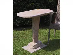 Travertine coffee table by Rolando Stefanacci, elongated oval top and shaped support, offered Jul 2026