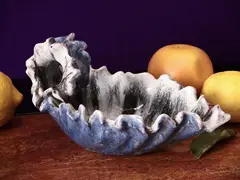 Enamelled terracotta cachet by Marcello Fantoni, Made as a wave and painted with shades in the tones of blue, offered Apr 2025