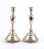 Josef Kurzweil, A pair of Austro-Hungarian silver candlesticks, 1874, of circular shape with foreal decorations.