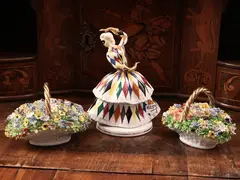 Pair of porcelain groups by Luigi Fabris, made as bouquets of flowers painted in polychrome contained in a wicker basket with braided handle and highlighted, offered Jul 2024
