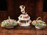 Luigi Fabris, Pair of porcelain groups, made as bouquets of flowers painted in polychrome contained in a wicker basket with braided handle and highlighted