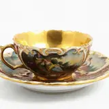 Jacob Petit, Porcelain collector's cup, painted with gallant and gender scenes within reserves on a magenta background embellished with extensive gold