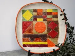 Large ceramic plate by Bruno Gambone, 1909, decorated with multicolored geometric motifs, offered Feb 2023