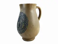 Salted stoneware jug, Thirties by Galileo Chini, painted and engraved in blue monochrome with opposing seahorses and geometric motifs within a circular reserve, offered Jun 2022
