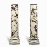 A pair of Pavonazzetto marble turned columns by Christo, resting on plinth base, offered Jun 2019